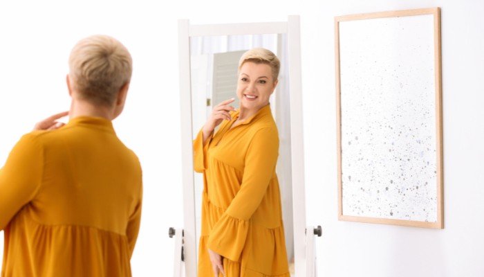 Short Haired Woman Looking in Mirror